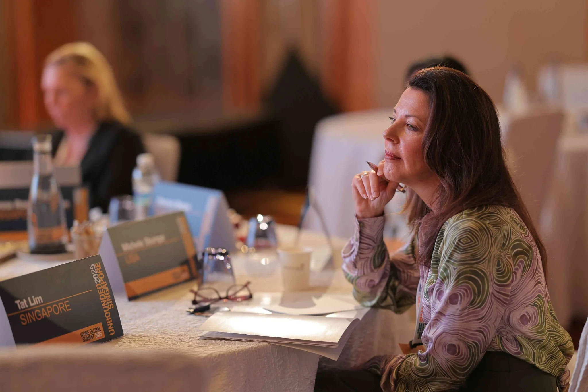 Senior participant listening in a business discussion